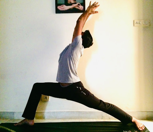 Pradip Sharma demonstrating side stretch yoga posture for spinal flexibility